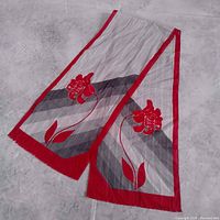 Entire scarf laid flat showing full design, grey stripes, red border, floral motif