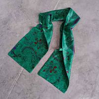 Full view of green paisley scarf laid flat