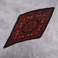 Full view of pleated scarf laid flat in diamond orientation