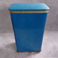Front view of blue metal hamper with gold trim