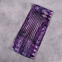 Full view of purple patterned scarf laid flat