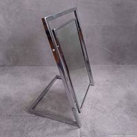 Three-quarter side view showing chrome frame and triangular base