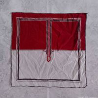 Full view of unfolded red and white silk scarf showing design and size