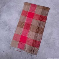 Full view of rectangular silk scarf showing colorblock pattern and fringe