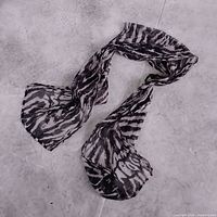 Full view of zebra print scarf laid flat