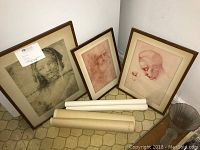 Three framed master drawing reproductions on the floor leaning against wall with three rolled posters in front. Shows overall condition and size comparison.