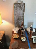 Photo showing the metal tray along with six vases, bowls, and small serving dishes arranged on a wooden surface.