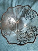 Top view showing silver floral overlay and scalloped rim