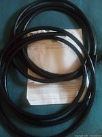 Coiled black cables laid over invoice