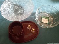 Overview of all items: brown mug and saucer, two clear glass bowls, pair small cube shakers