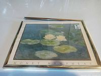 Front view of Monet print showing artwork, gold frame, detached top rail, size sticker