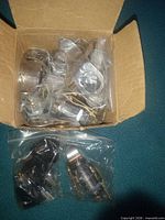 Open box showing multiple individually bagged cam locks and keys