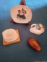 Group shot of all four souvenirs and stand