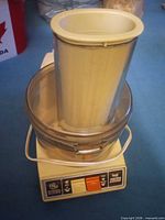 Full view of assembled food processor with pusher inserted