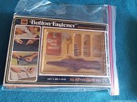 Front of boxed PICAM Button Fastener kit in zip bag showing contents