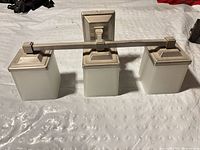 Front view of 3-light brushed nickel vanity light with frosted glass shades