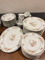 Full set stacked: plates, bowls, cups, saucers, platters
