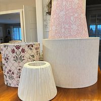 Four lampshades grouped showing colors, patterns and sizes