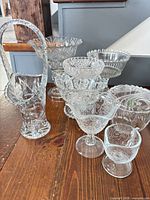 Group shot of all eight clear pressed and cut glass pieces