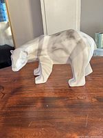 Side view of marbleized resin bear sculpture