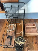 All five wall pieces laid out: wire basket, wood/wire shelf, mail holder, wood hook rack, decorative moth hook
