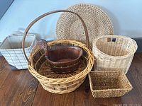 Six baskets arranged on wooden floor