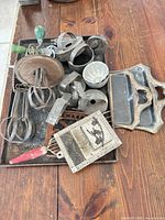 Top view of tray holding assorted vintage metal kitchen tools and bakeware