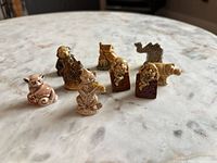 Group of nine Wade porcelain miniatures front view on marble surface