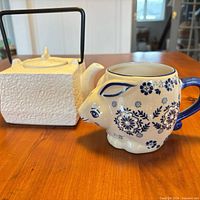 Front view of square teapot and bunny mug