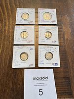 All six coins in flips showing obverse sides