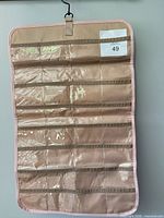 Front view showing clear PVC pockets and hanging hook