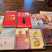 All ten paperback books laid out in two rows on table