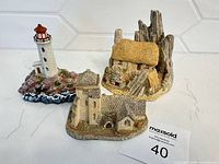 Group shot of lighthouse and two cottage figurines