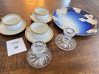 Full lot view showing tea cups, saucers, platter and candlesticks