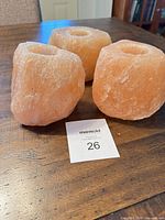 Three pink Himalayan salt candle holders grouped on table top