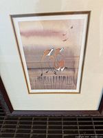 Stylized foxes print framed under glass