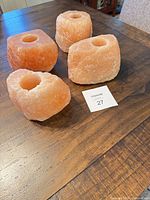Four Himalayan salt candle holders on table
