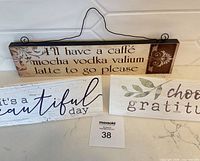 All three wooden wall signs displayed together