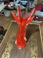 Full view of red art glass vase on table