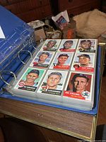 Binder open displaying nine Baseball Archives cards of 1950s players in plastic sleeve page