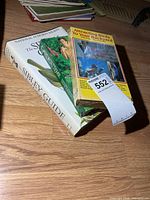 Stack showing Sibley guide book, Attracting Birds to Your Backyard VHS and Garden Time VHS