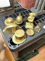 All brass items arranged on shelf