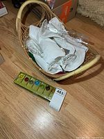 Basket containing clear champagne glasses and packaged glass markers
