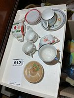 Tray showing entire assortment of miniature tea set pieces