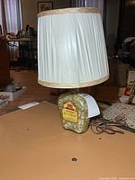 Full view of lamp showing bottle base and shade