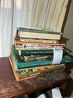 Full stack of gardening books on side table