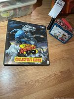 Binder and mini tin lunch pail grouped on floor