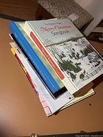 Stack of music books showing several covers and spines