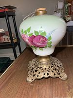 Oil lamp profile showing painted glass body and cast metal base