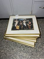 Stack of framed Pearl Harbor photos showing leis scene print